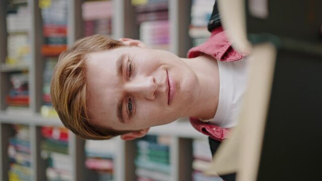 Redhead guy reads book to find information for examination
