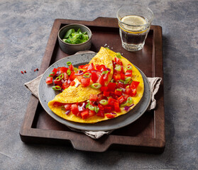 omelette with tomato, bell pepper onion chili and cheese. healthy breakfast