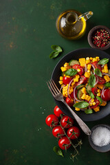 Fototapeta na wymiar healthy vegetarian tomato sweet corn salad with cucumber and basil