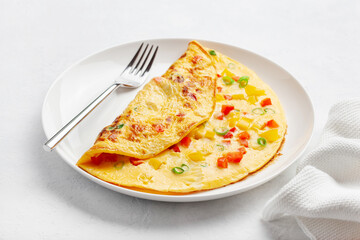 omelette with tomato, bell pepper onion and cheese. healthy breakfast