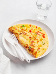 omelette with tomato, bell pepper onion and cheese. healthy breakfast