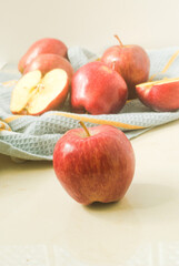 Red apples in a kitchen towel on a kitchen top 