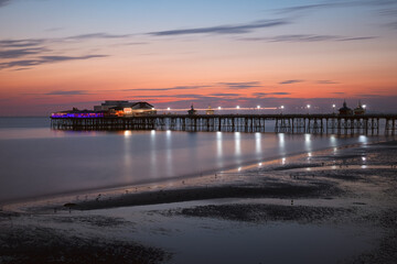 Fototapeta premium Pier with attraction in the evening after sunset in Blackpool beach. England, UK