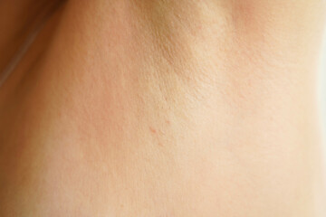 Women's armpit close-up. Thin and sparse hair on a female armpit. The result after completing an...