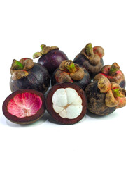 Mangosteen and cross section showing the thick purple skin and white flesh of the queen of friuts, on white background
