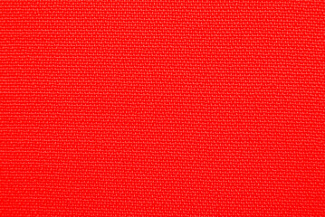 Close-up long and wide texture of natural red fabric or cloth in light red color. Fabric texture of natural cotton or linen textile material. Red canvas background.