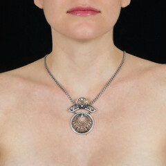 Attractive female silver chain with pendant hangs around neck of