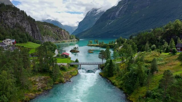 Lake bottom Loenvatnet with glacial river starting to flow dowm Lodalen valley - moving aerial