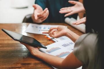 Businessmen and women talk about charts, stock market, projects, business, real estate. In the new office. Team work. Concept of success. Success at work. brainstorming at office desk, analyzing