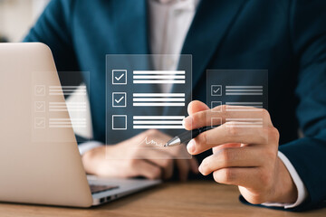 Electronic signature concept, business man using stylus pen to approve digital document on screen like using stylus pen, paperless office Signing future business contracts.