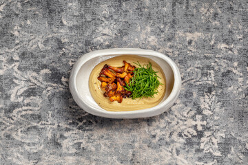 Hummus with fried chanterelle mushrooms.