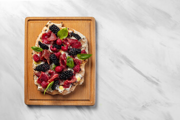 Pinza with berries and prosciutto