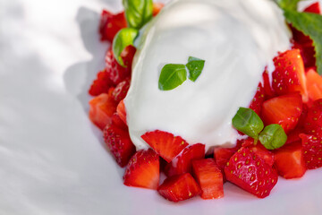 Vanilla ice cream with strawberries and basil.