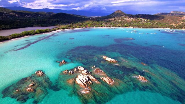 Best beaches of Corsica island - aerial video of beautiful Santa Giulia long beach with sault lake from one side and turquoise sea from other