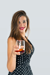 smiling woman offering a glass of wine for a toast