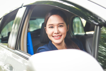 Beautiful Asian woman driving to work Happy smile. The concept of transportation. beautiful business woman sitting in the car