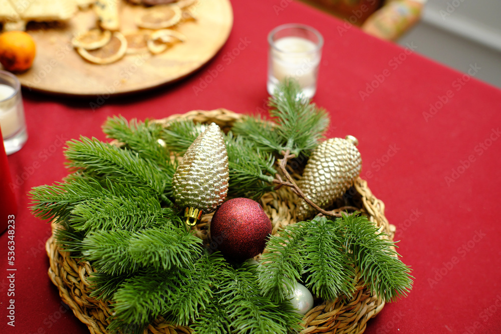 Sticker christmas table setting. a vase with artificial christmas tree branches and christmas balls stands o