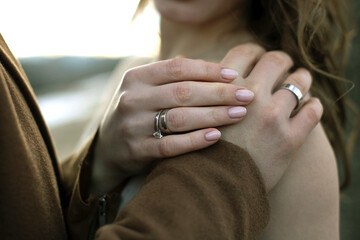 Hands of a couple in love with rings