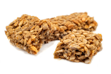 Candy or candy bar made from sweet sunflower seeds on a white background. seeds