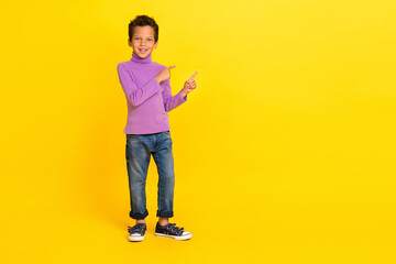 Fototapeta na wymiar Full body photo of cheerful funny boy indicate fingers empty space offer isolated on yellow color background