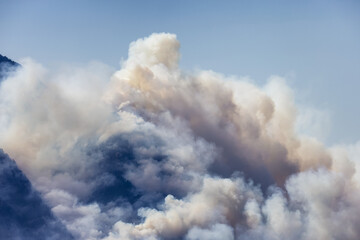 BC Forest Fire and Smoke over the mountain near Hope during a hot sunny summer day. British Columbia, Canada. Wildfire natural disaster