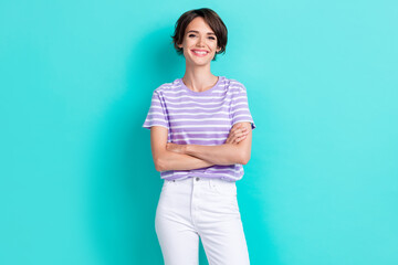 Photo of positive nice looking lady arm crossed dressed fashionable striped clothes show bright grin isolated on cyan color background
