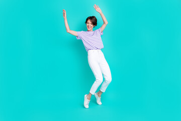 Fototapeta premium Full length photo of pretty funky girl dressed purple t-shirt dancing having fun isolated teal color background