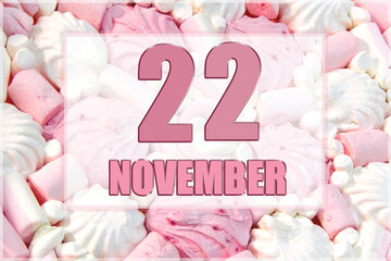 calendar date on the background of white and pink marshmallows. November 22 is the twenty-second...