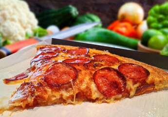 Pizza with pepperoni, mozzarella and tomatoes