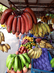 Red, yellow and green bananas in a fruit stall, healthy organic food, fruit. Autumn harvest, farmers market.
