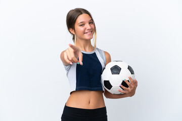 Little caucasian girl playing football isolated on white background pointing front with happy...