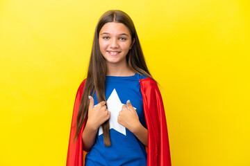 Little caucasian superhero girl isolated on yellow background with surprise facial expression