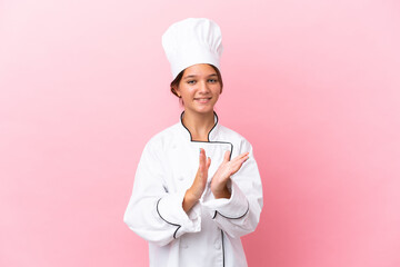 Little caucasian chef girl isolated on pink background applauding after presentation in a conference