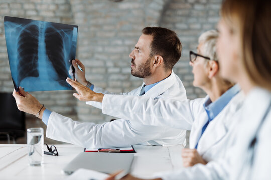 Group of doctors examining X-ray image during a meeting in the office