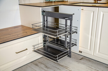 Retractable metal shelves in kitchen furniture