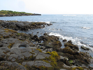 Fototapeta na wymiar Black sand and rock Beach in Hawaii