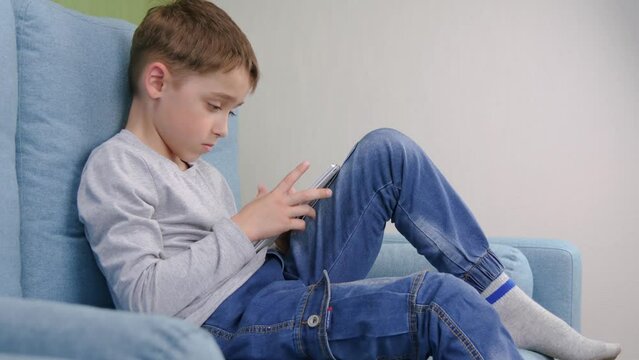 The child undergoes distance learning through online video training, the Internet, using a tablet, at home. The concept of home remote learning.