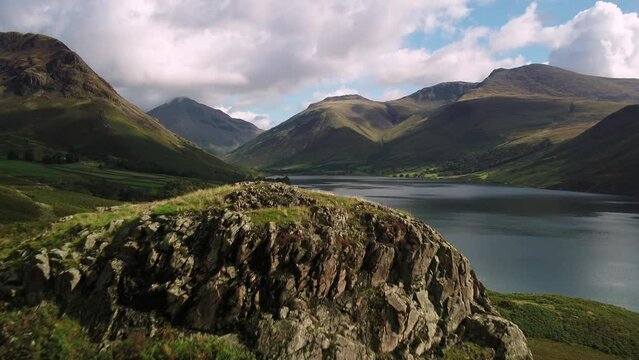 The sun lights up trees on the shore of Wastwater in the lake district
