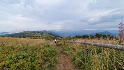 A silhouette of a tourist and a stunning view of the mountains. Bieszczady National Park, the Carpathians, Poland.
