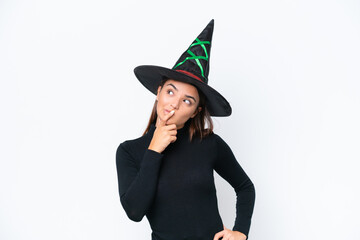 Young caucasian woman costume as witch isolated on white background having doubts and with confuse face expression