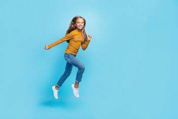 Fototapeta na wymiar Full length photo of excited sportive person jumping rush fast isolated on blue color background