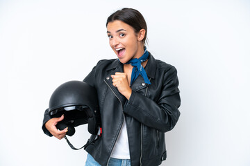 Young caucasian woman with a motorcycle helmet isolated on blue background celebrating a victory