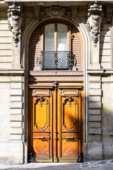 Paris, an ancient sculpted door, beautiful facade in a luxury neighborhood
 - obrazy, fototapety, plakaty