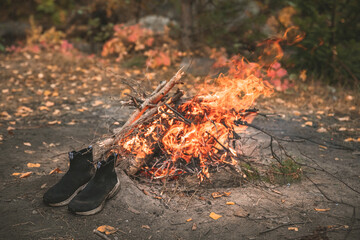 shoes near the campfire, active outdoor recreation, camping