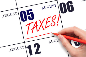 Hand drawing red line and writing the text Taxes on calendar date August 5. Remind date of tax payment