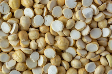 pile of roasted or fried bengal gram, also known as chenna dal or pori or pottu kadalai, healthy indian crispy snack in full frame, food background
