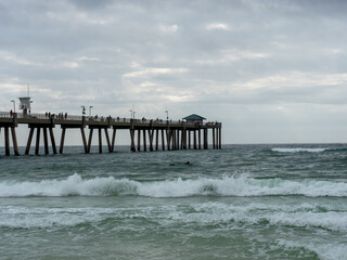 Ocean pier with cloudy sky
