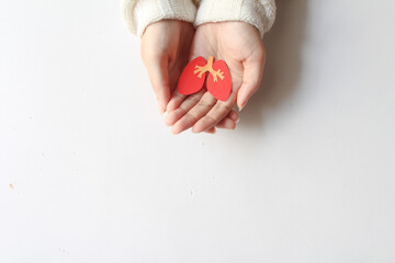 hand holding lung shape made from paper on white background with copy space, world tuberculosis...