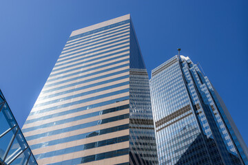 Fototapeta na wymiar Business office tower from low angle with blue sky