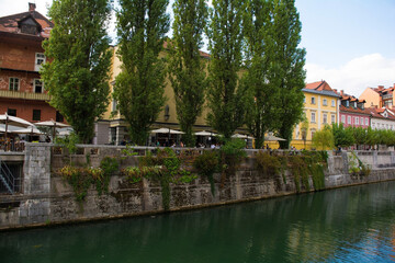 Fototapeta na wymiar Restaurants and bars on the waterfront of the Ljubljanici River in central Ljubljana, Slovenia 